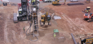 Image shows earth drill that is part of the shoring processes for the Civic Tower project 