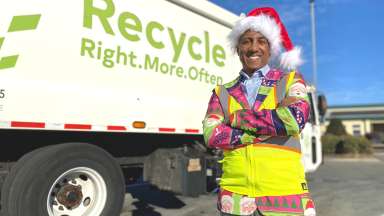 Solid Waste Services Director, Stan Joseph dressed in Santa hat and very festive sports jacket and safety vest.