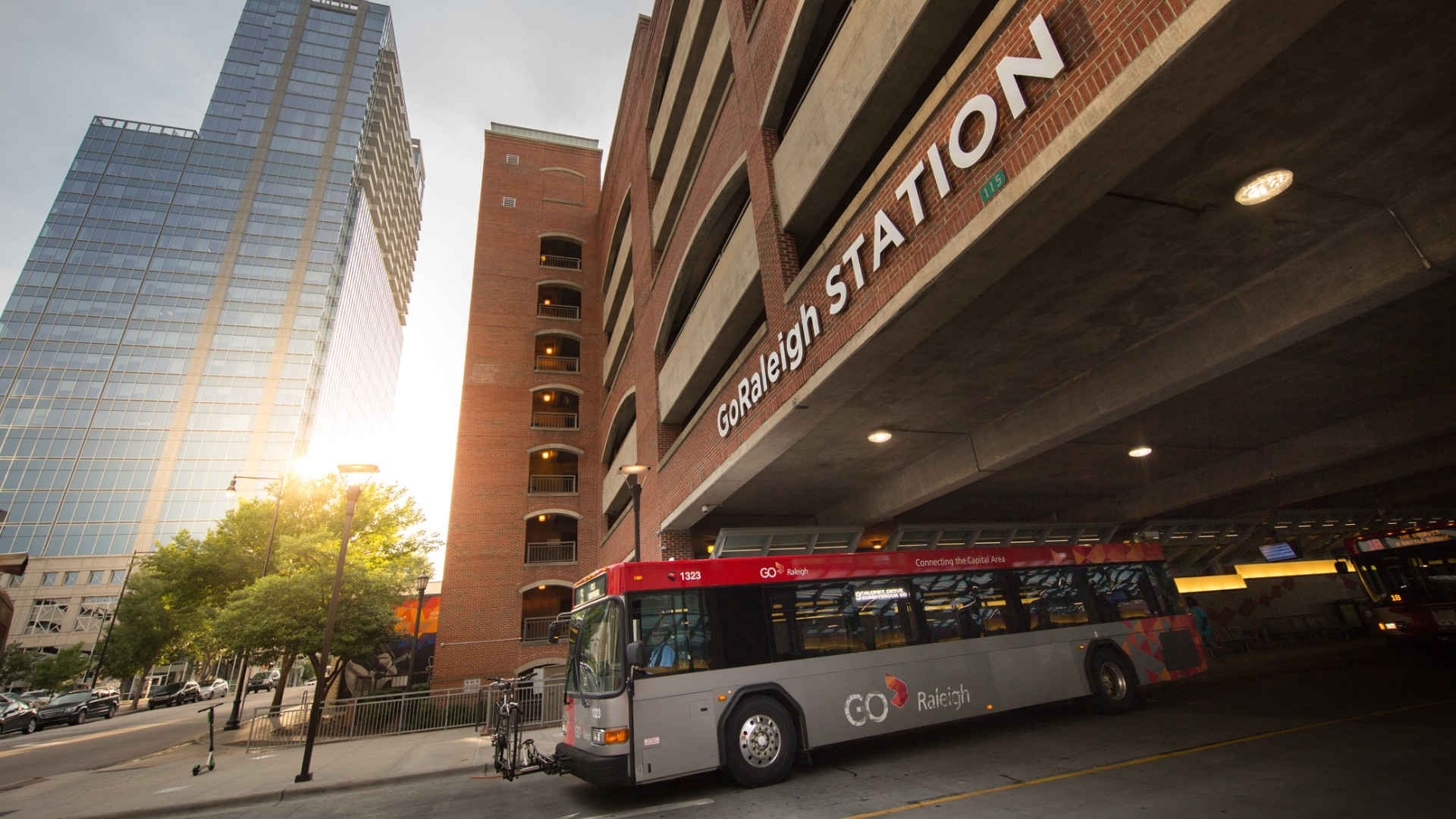 GoRaleigh bus existing the station with skyscraper in the background