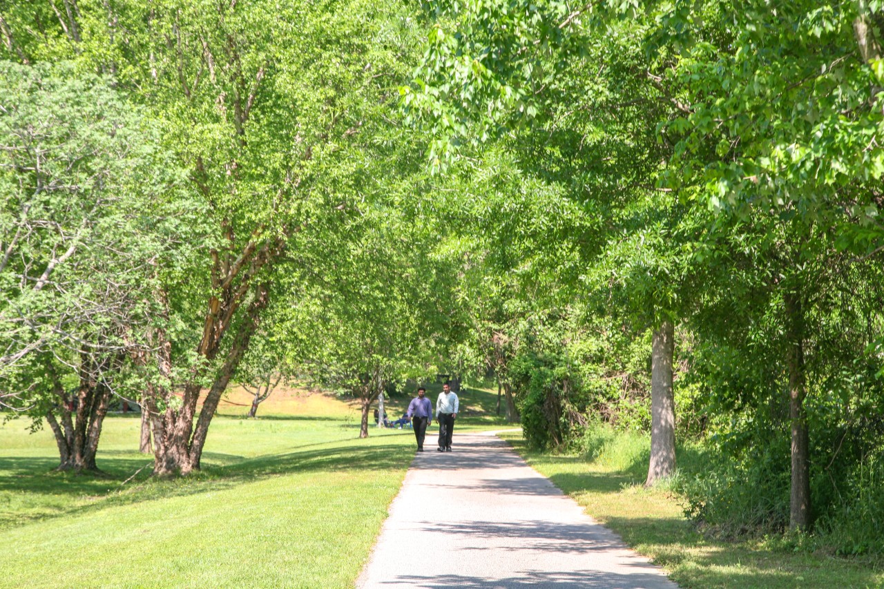 Two people walking on the greenway together