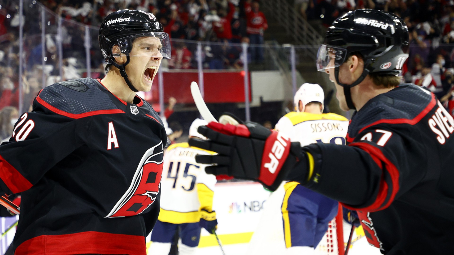 Carolina Hurricanes hockey players celebrating win by feeding each other bananas 