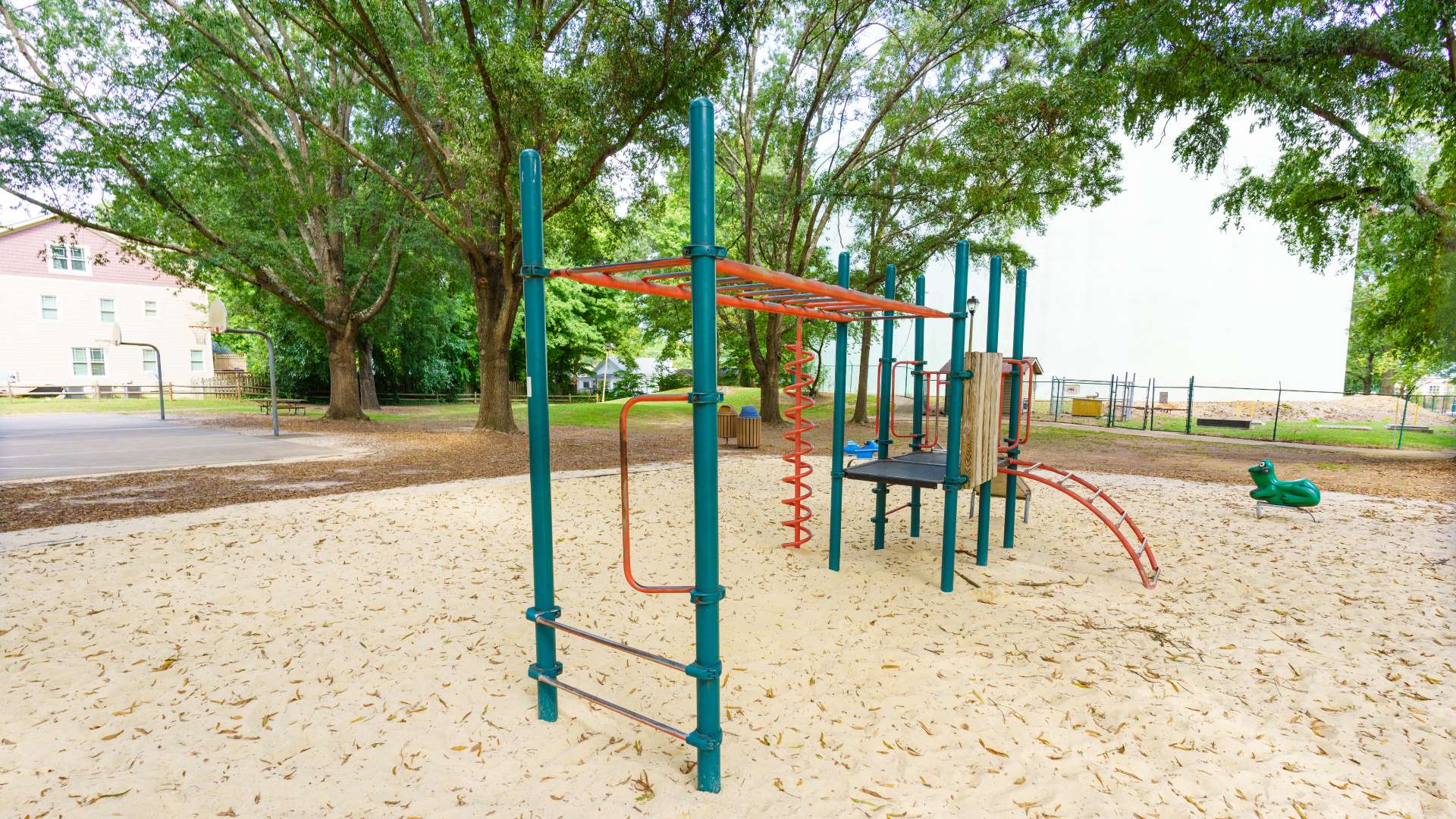 Chamberlain Park playground with basketball court in background