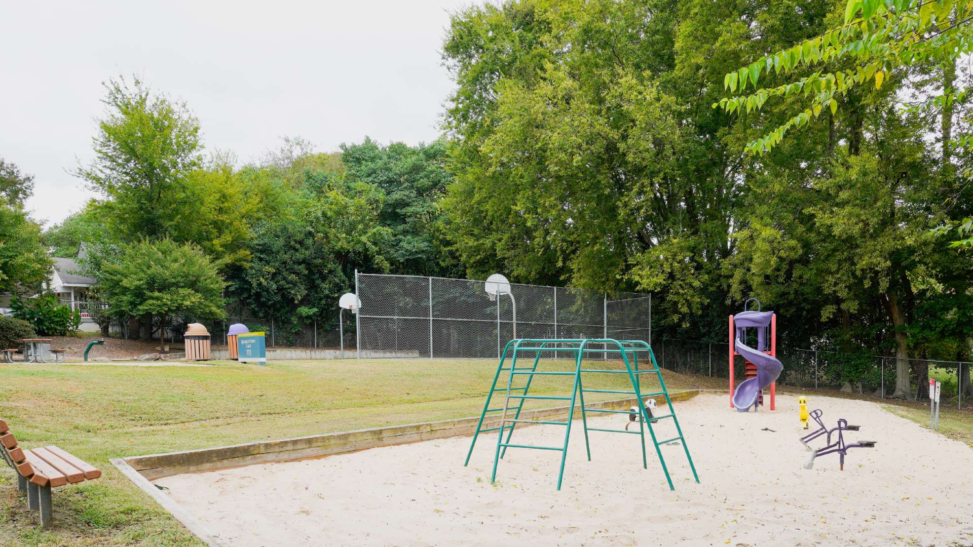 Quarry Street Park playground with basketball court in background