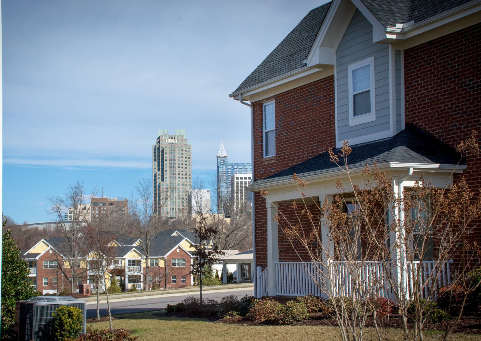 Exterior of affordable housing property with downtown Raleigh in the background