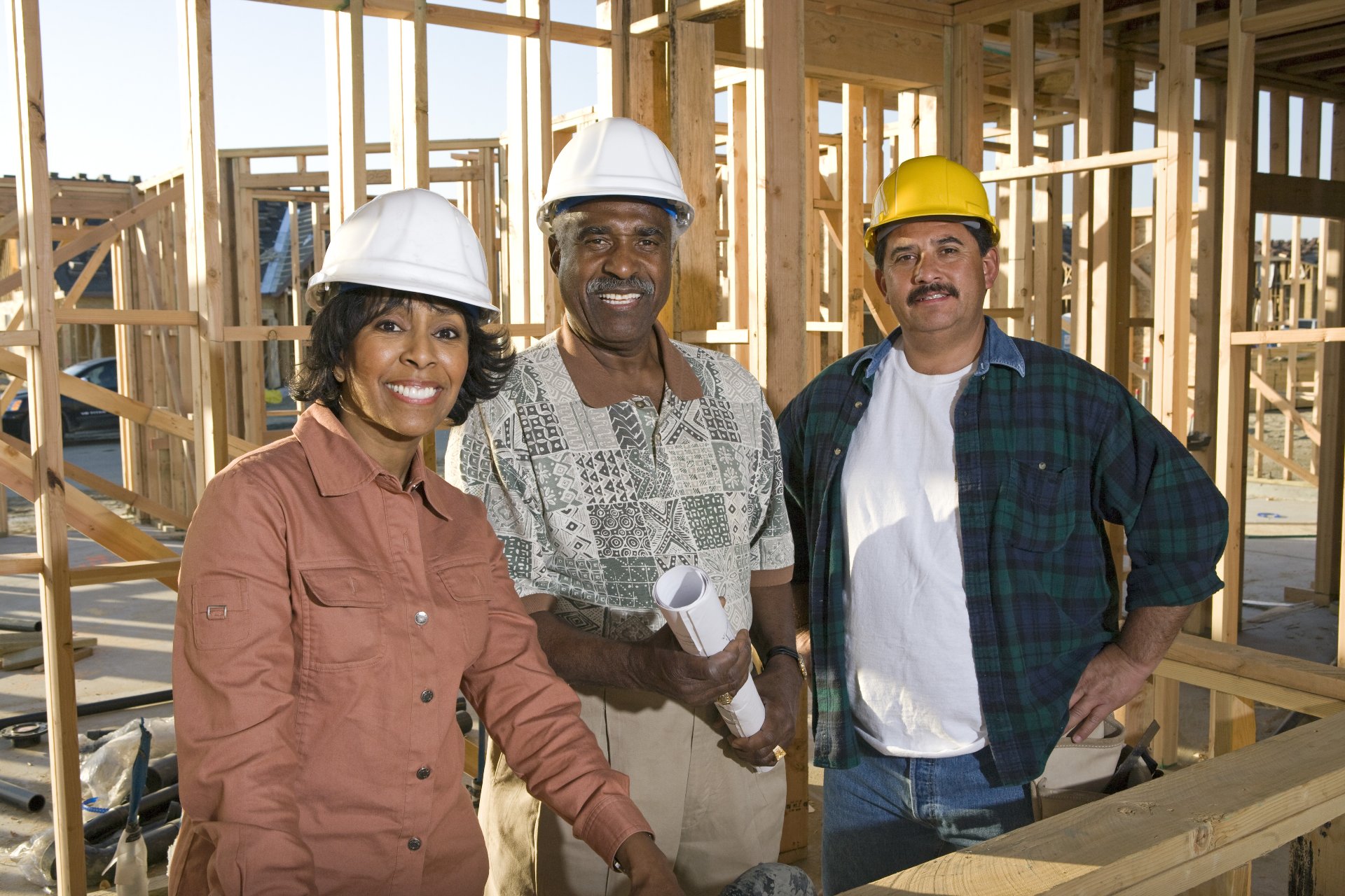 Diverse group of construction workers standing at a site 