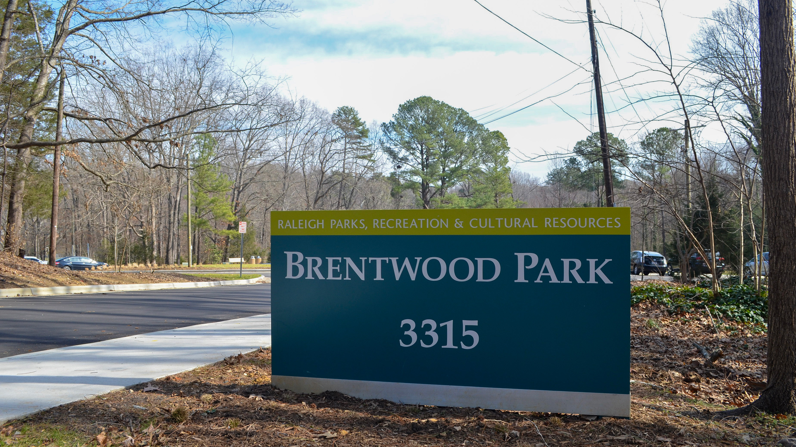 Sign at Brentwood Park. Next to a sidewalk