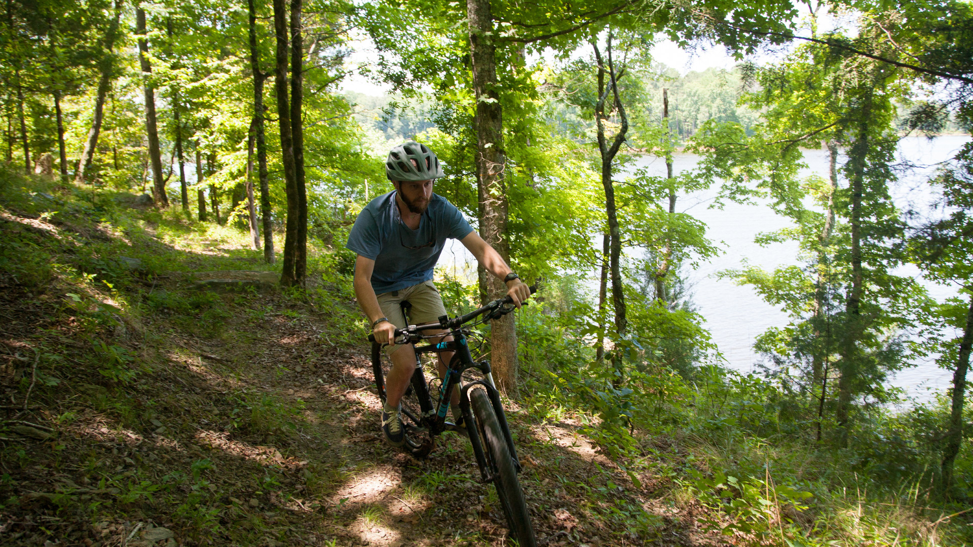 A man mountain biking in a forest.