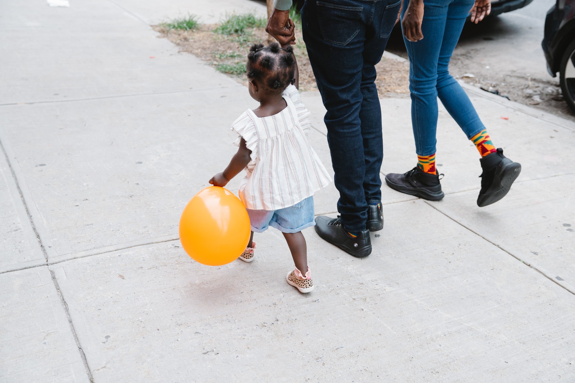 family walking on sidewalk