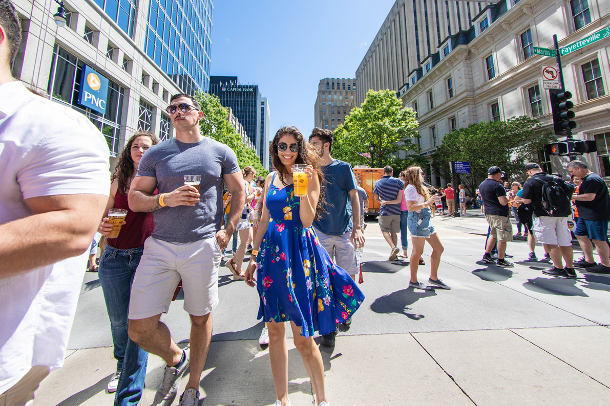 event attendees drink beverages in downtown raleigh
