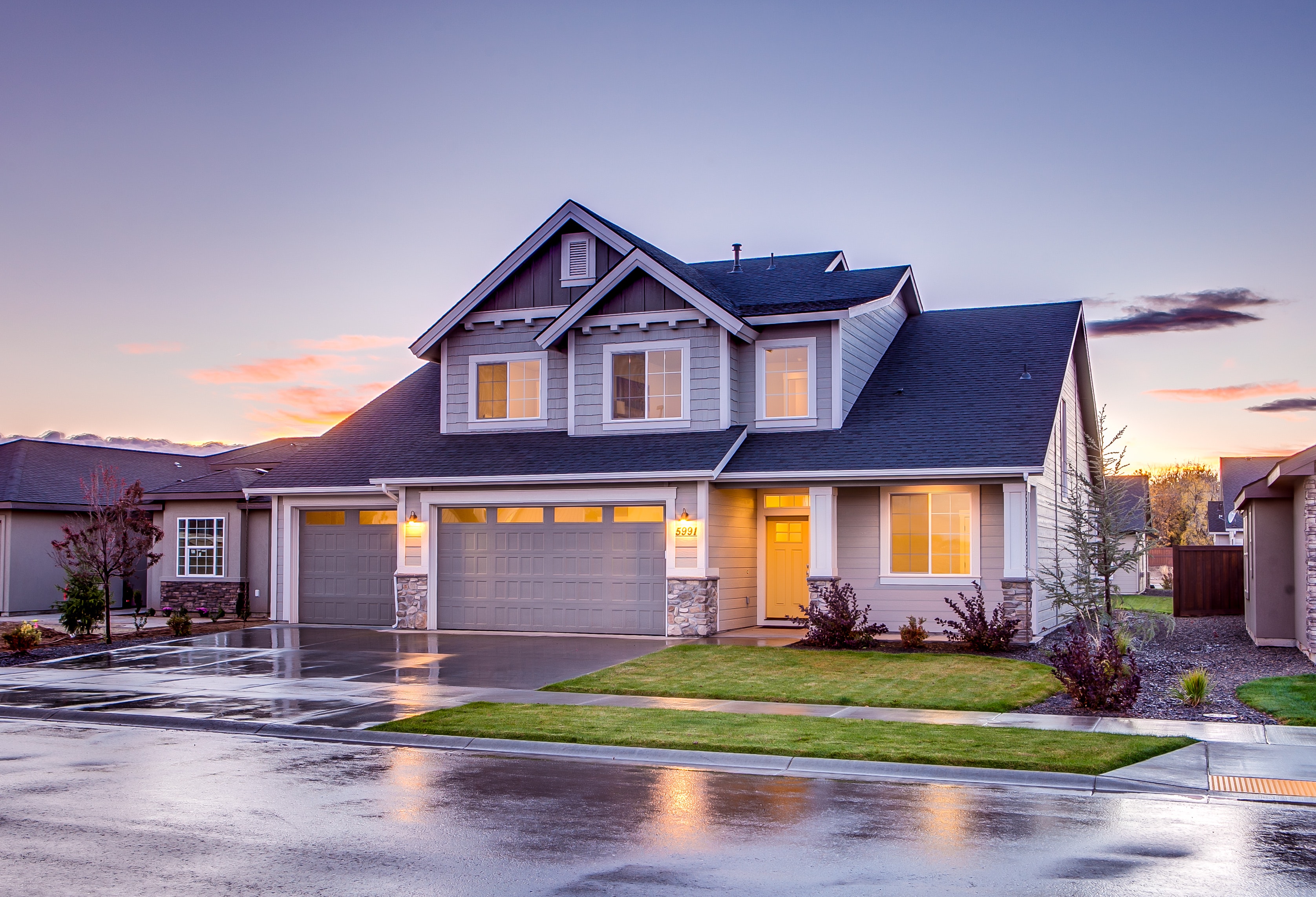 A two-story residential home with a short driveway.