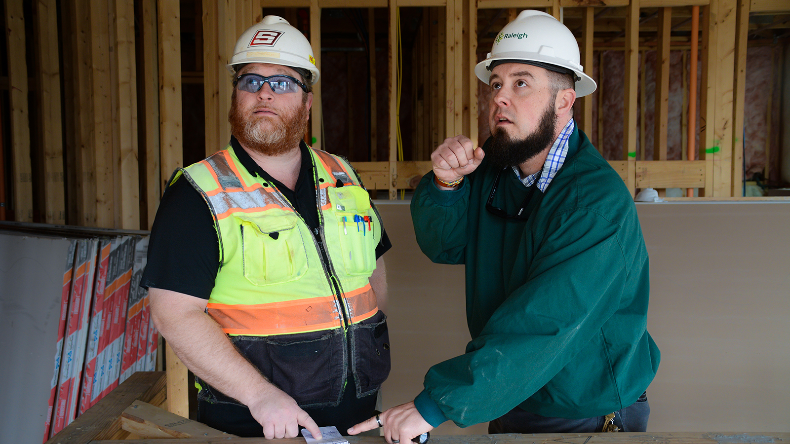 Two inspectors in a construction home making sure the building is safe.