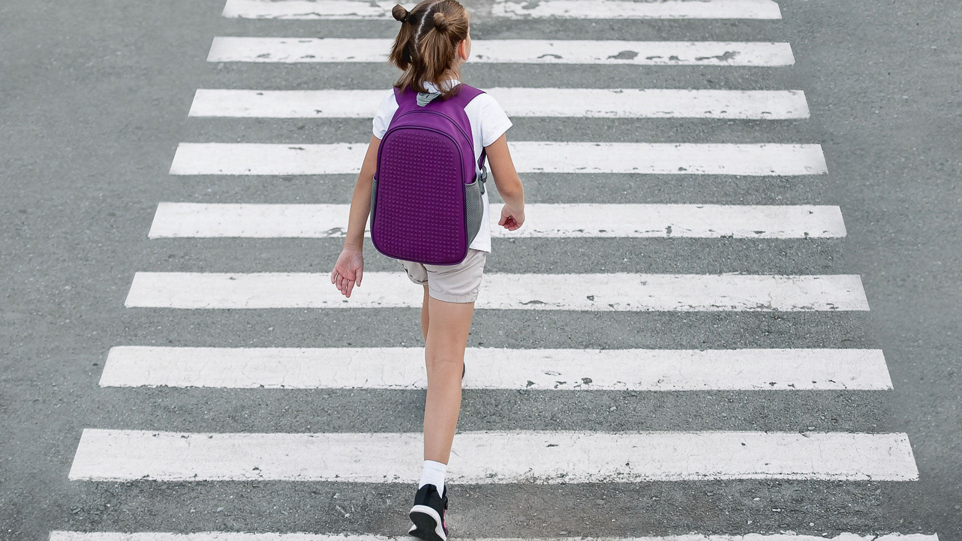 Child walking in crosswalk 