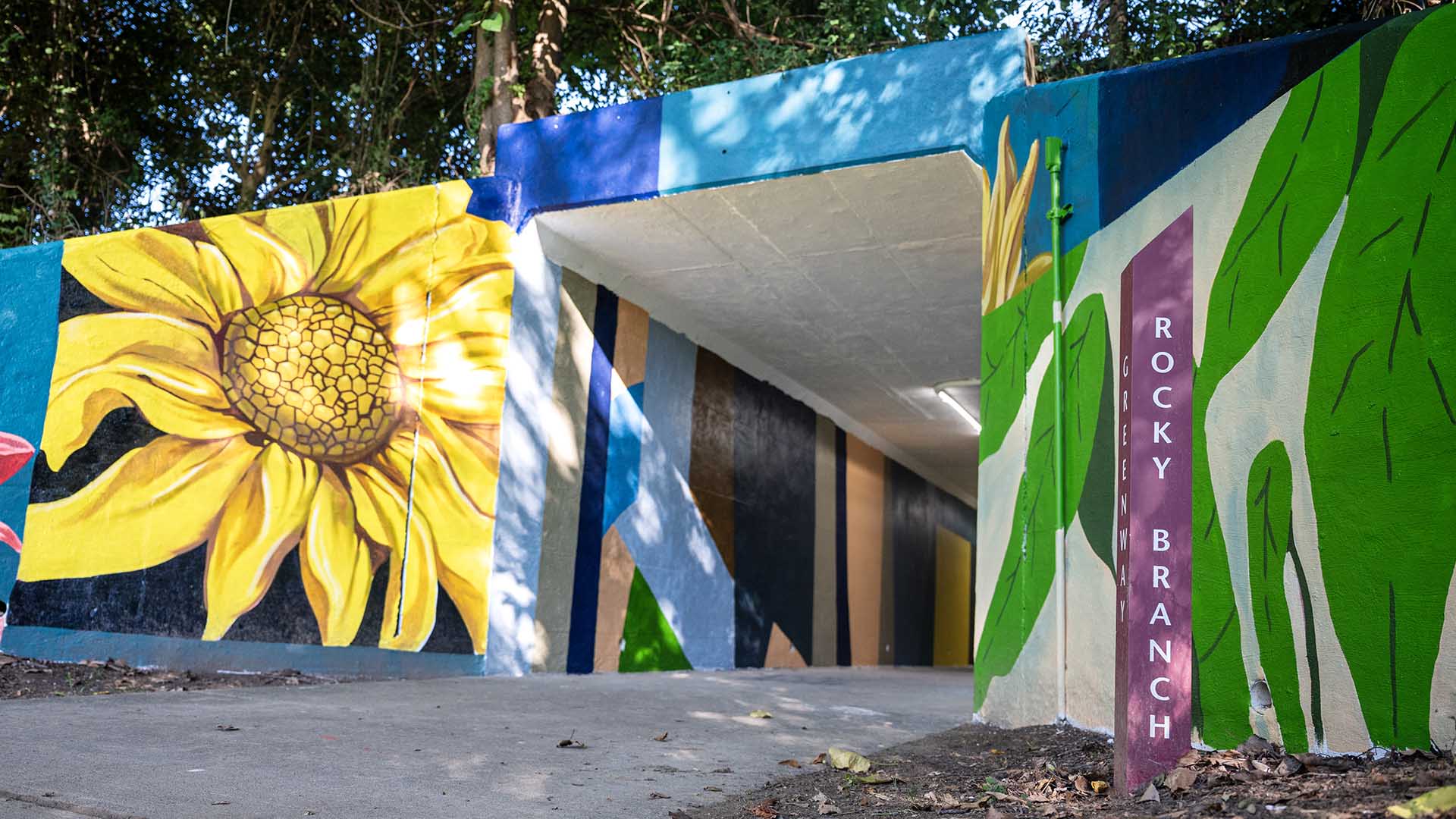 Sunflowers and other plants on the outside walls of a tunnel