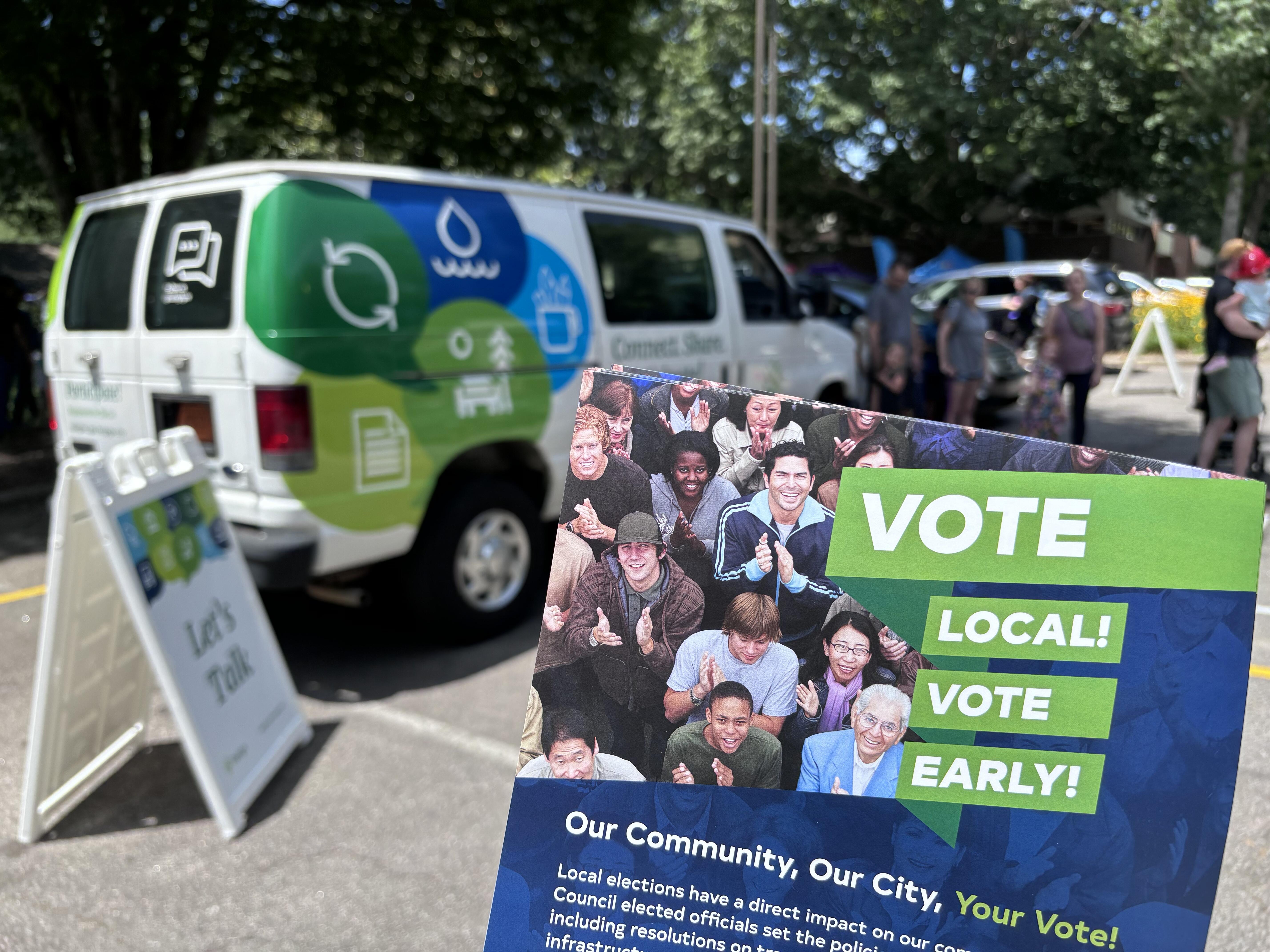 Vote Local Flyer with the community engagement van behind