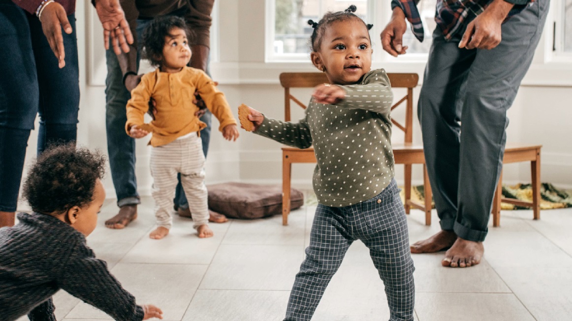 young child dancing with peers