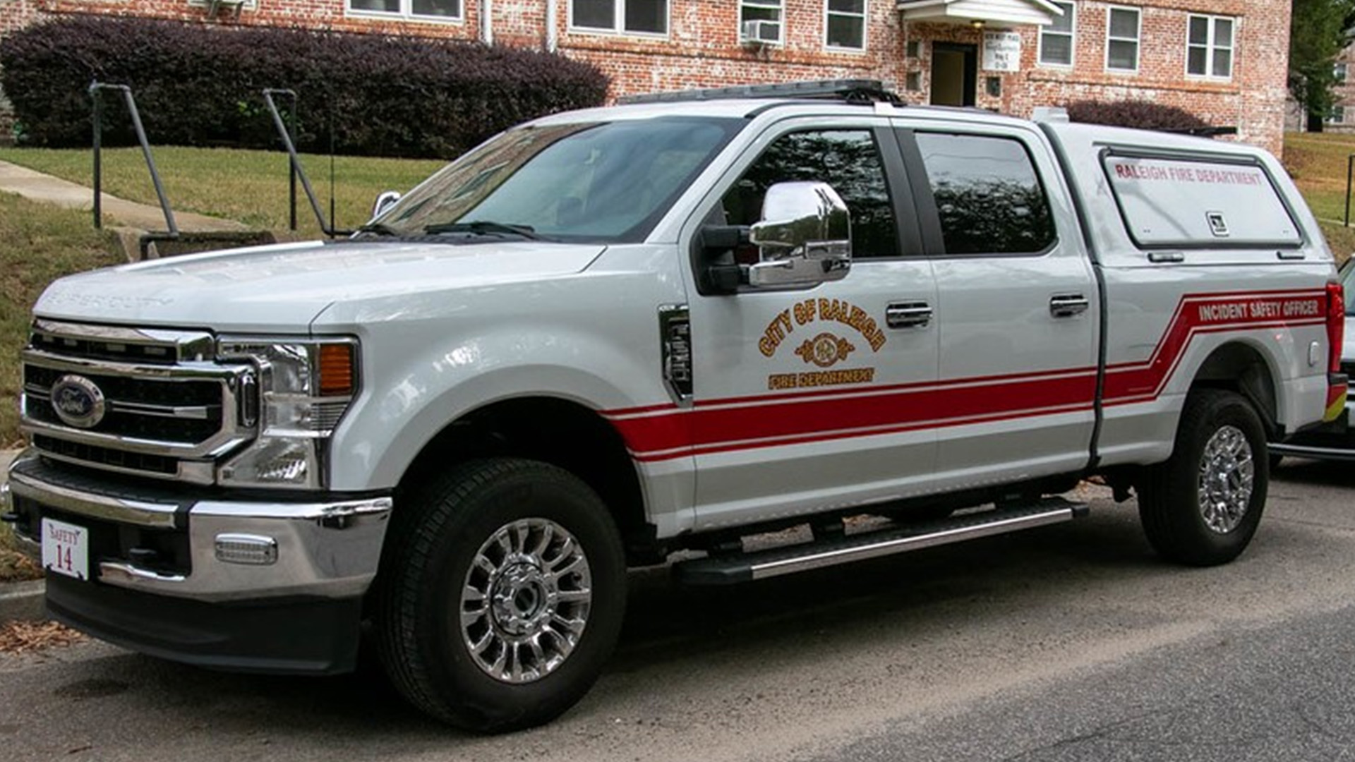 A white City of Raleigh Fire Department truck with "incident safety officer" written on the side
