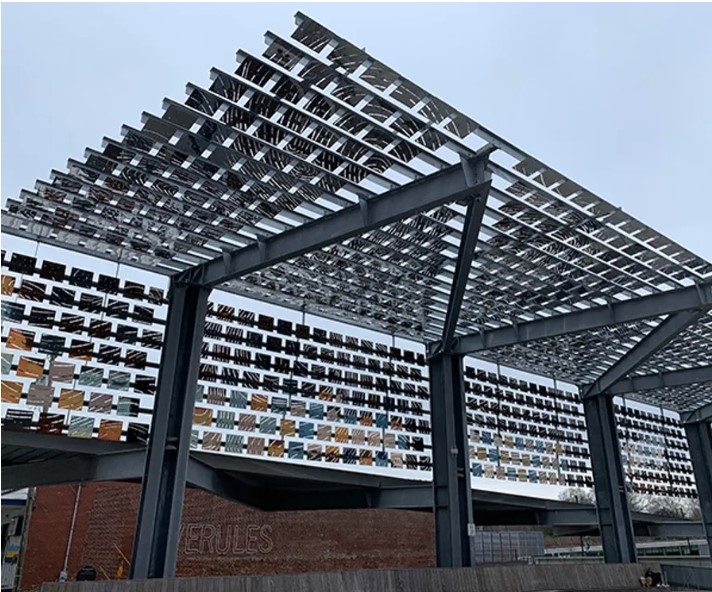 Reflective metal squares covering an angled outdoor canopy. 