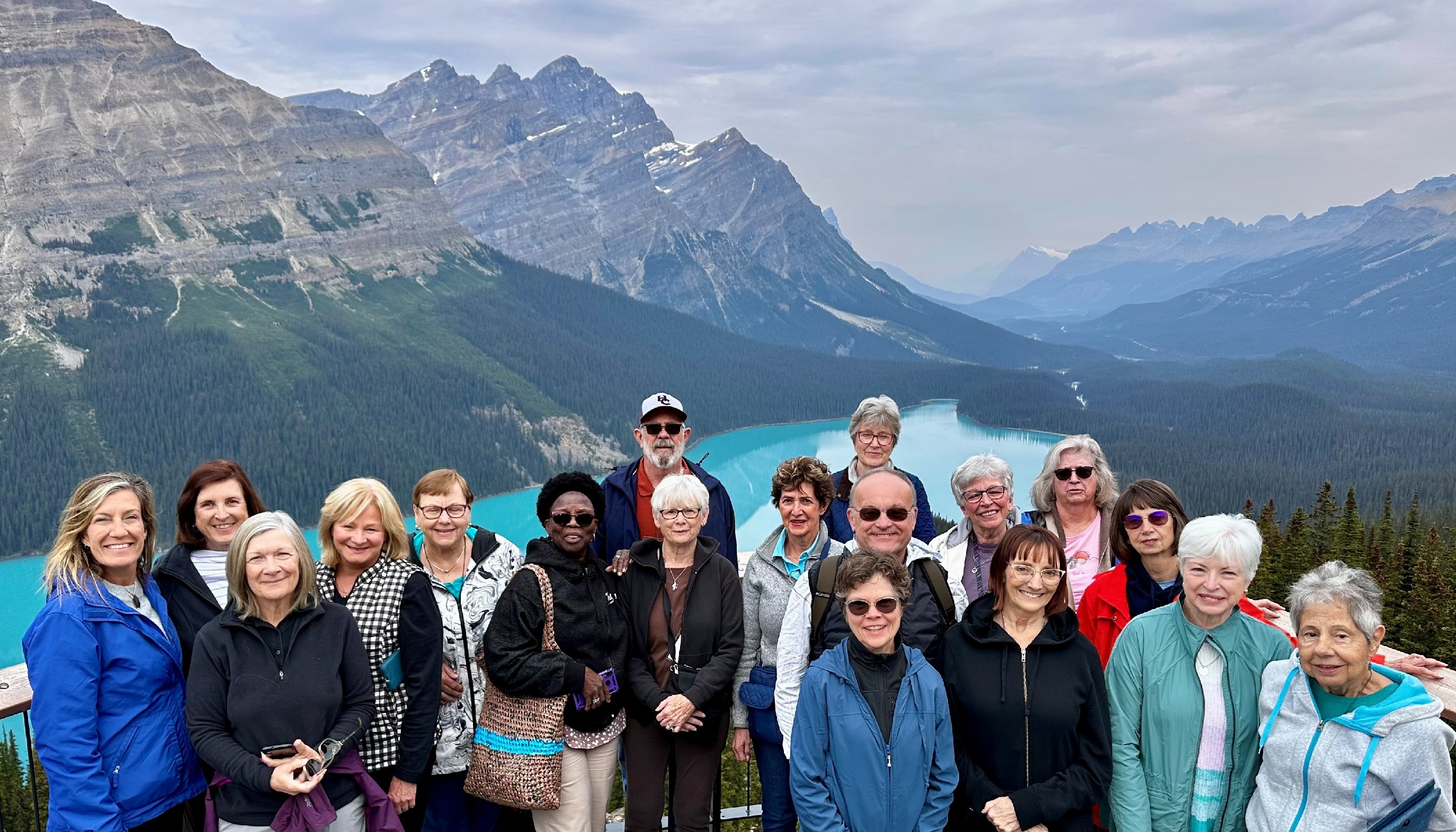 group of people in front of a pretty lake