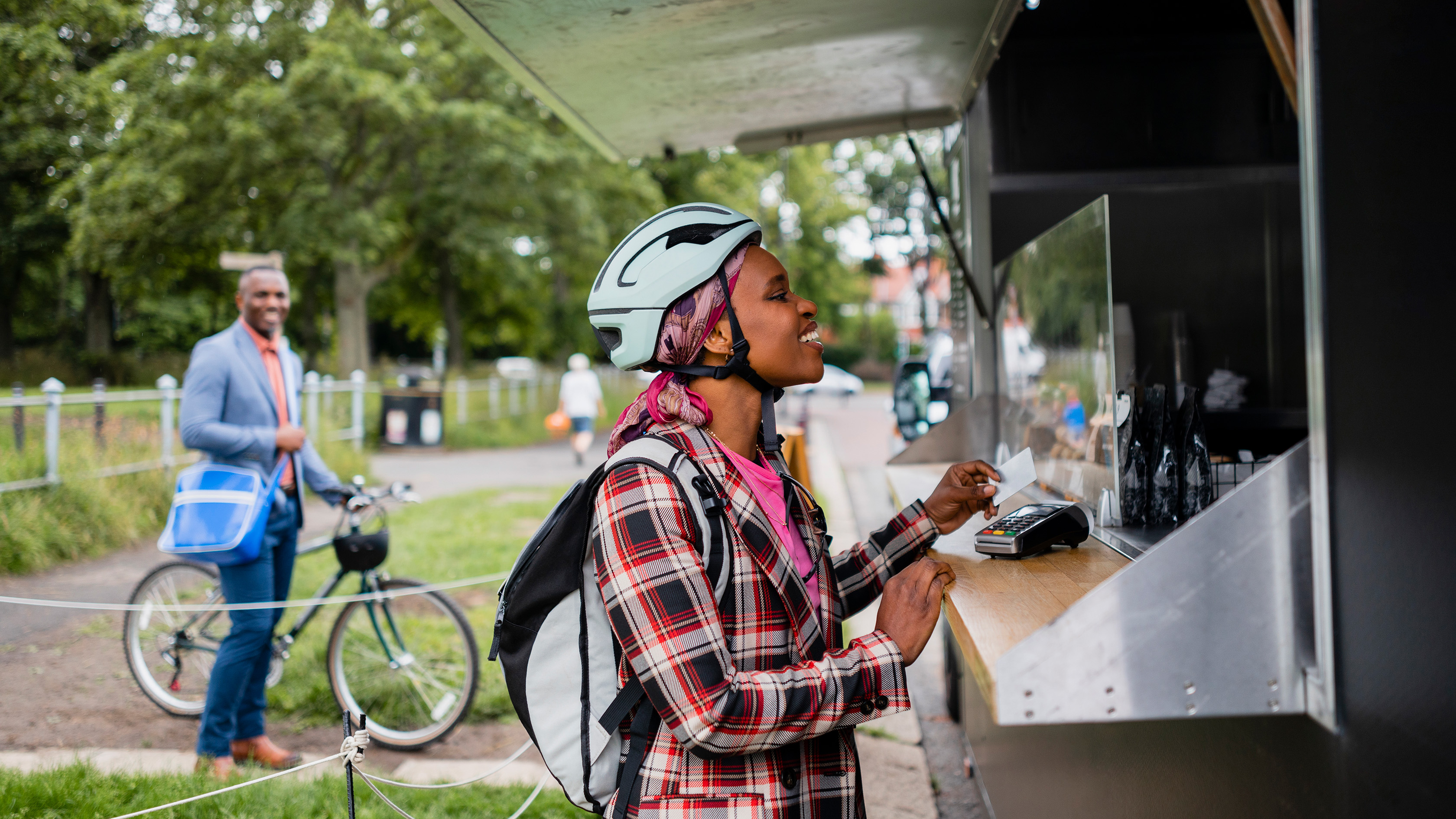 a person on the greenway purchasing a delicious snack from a food truck