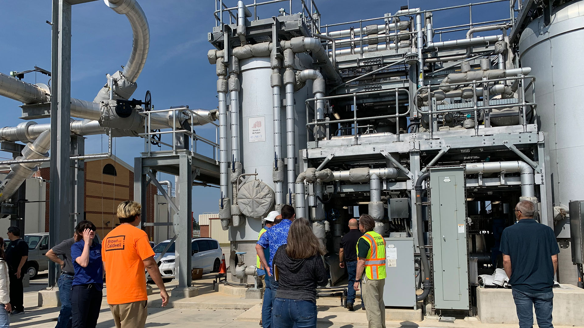Group of people talking on a tour of the bioenergy facility