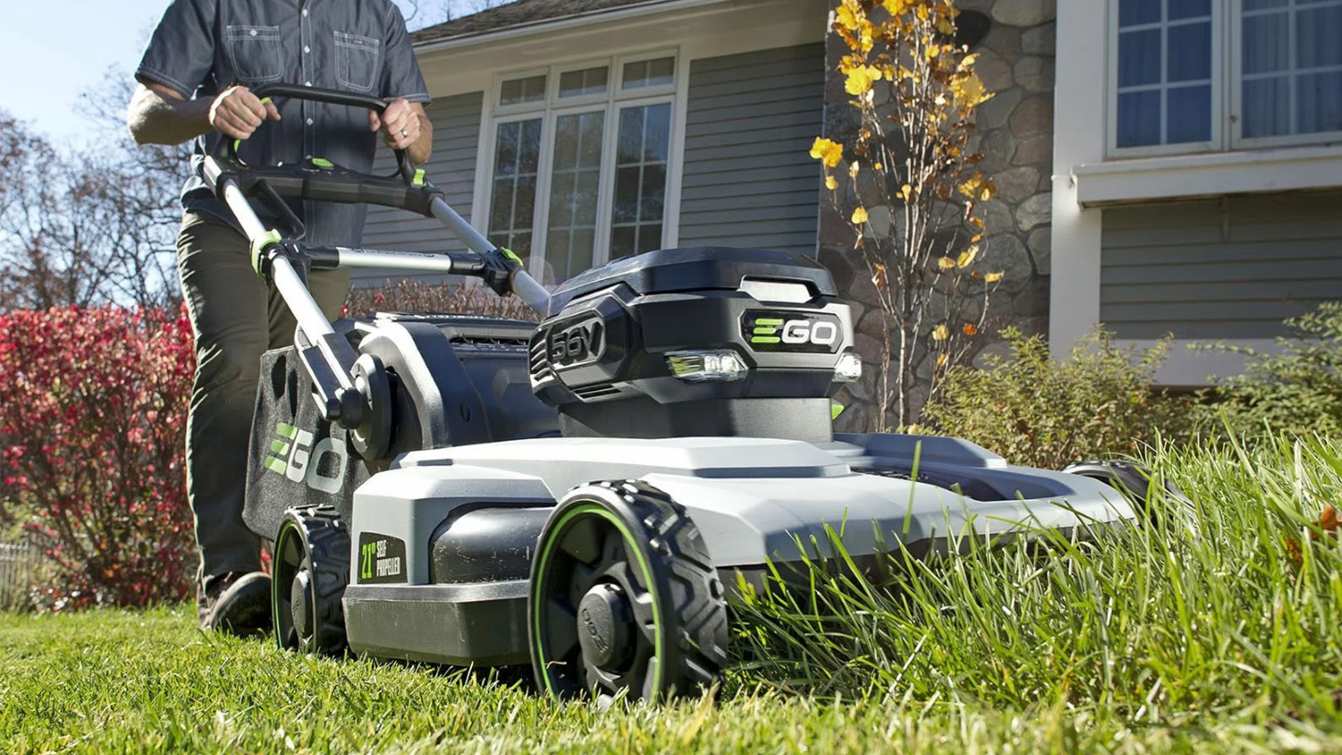 Man mowing with electric lawn mower