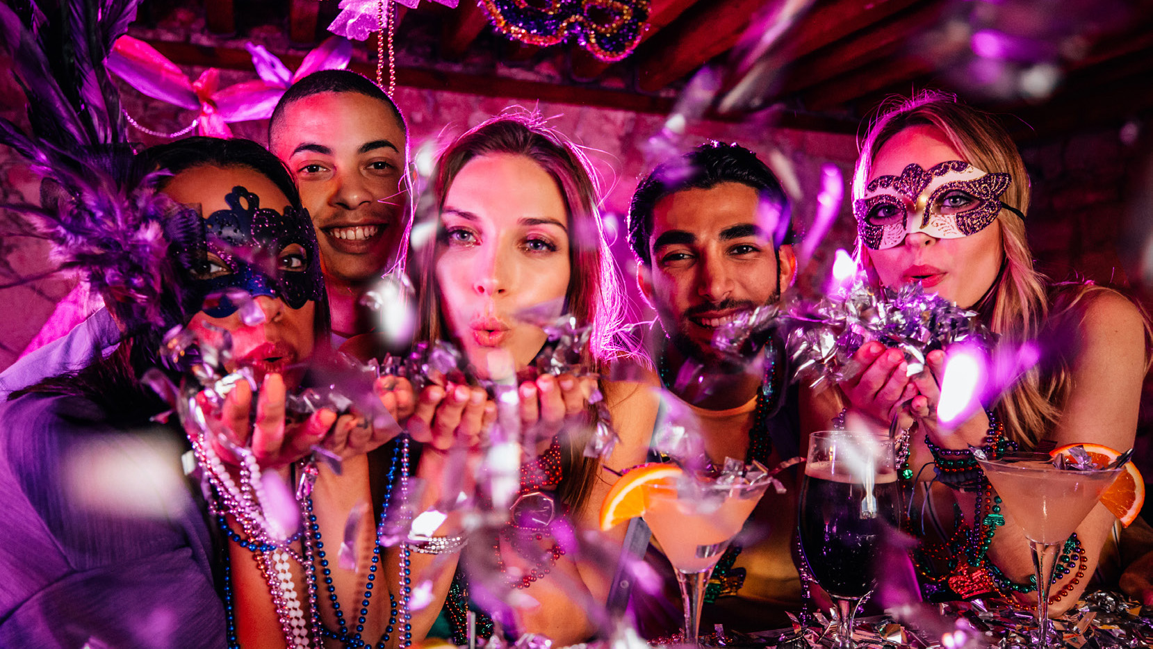 happy people with masks at a party