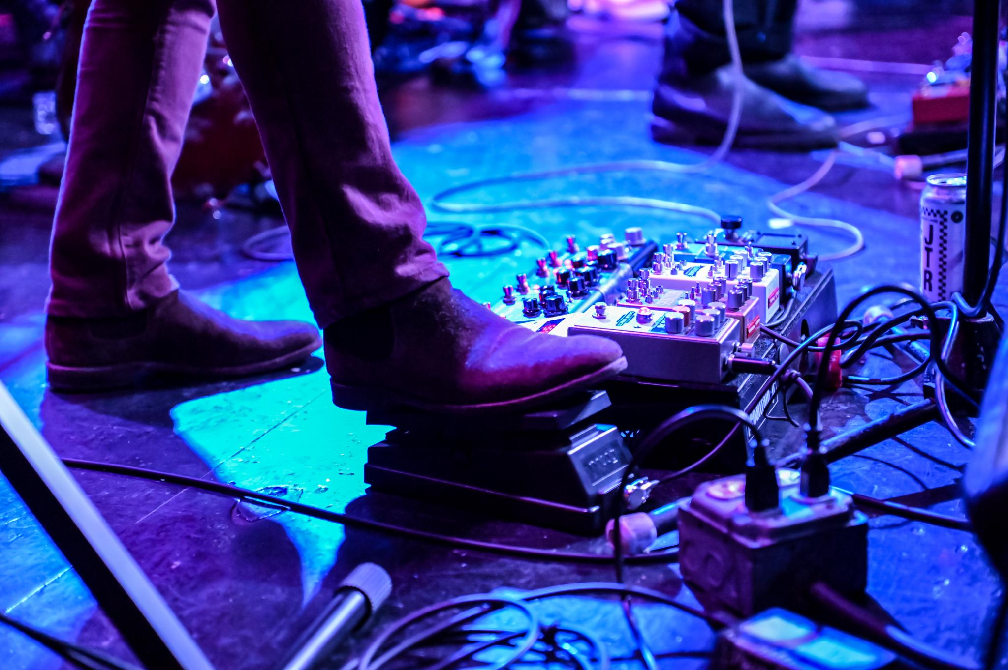 close-up of a musician's foot on a pedal during a live performance