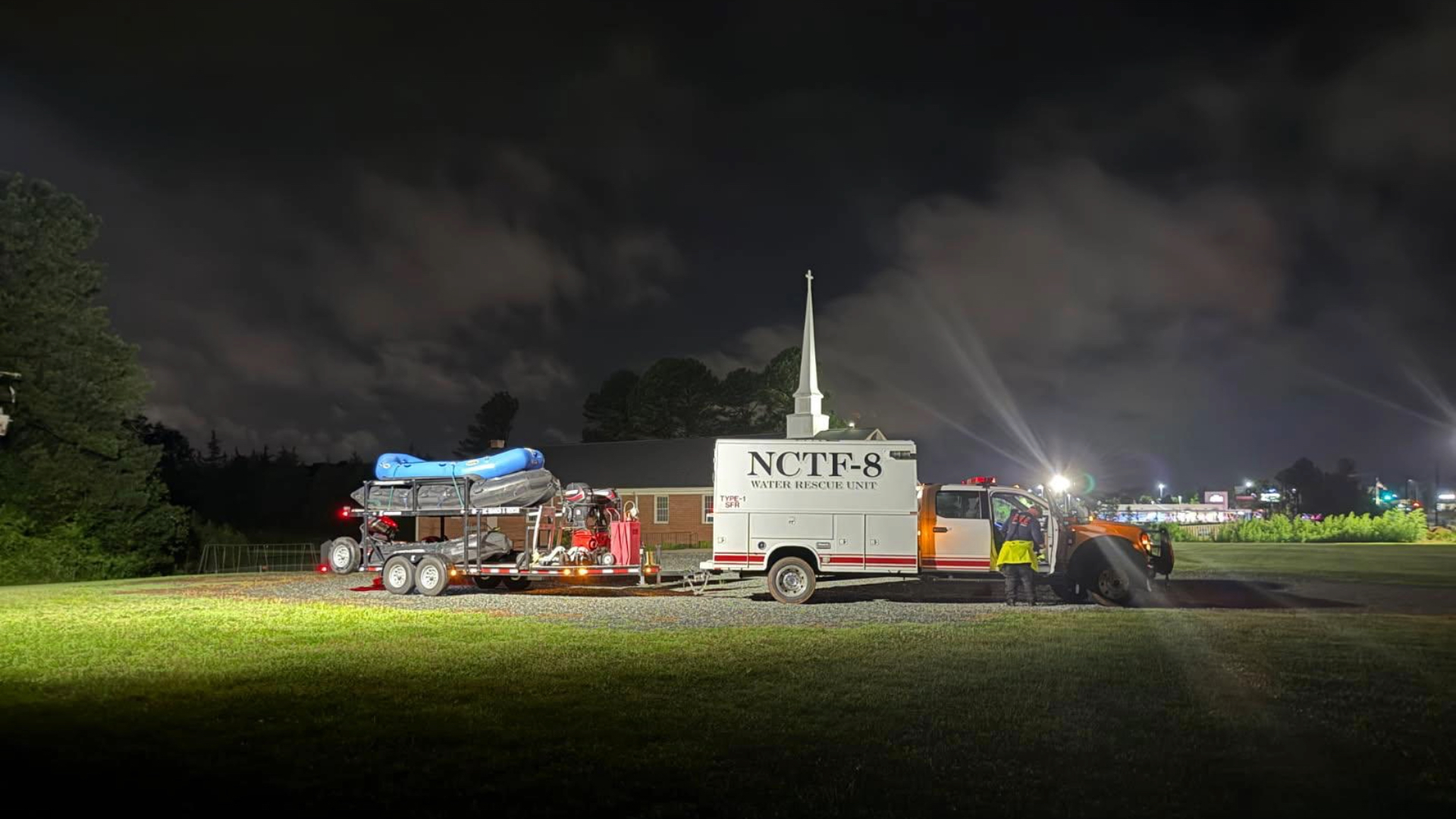 Image of RFD water rescue unit's truck parked on grass at night