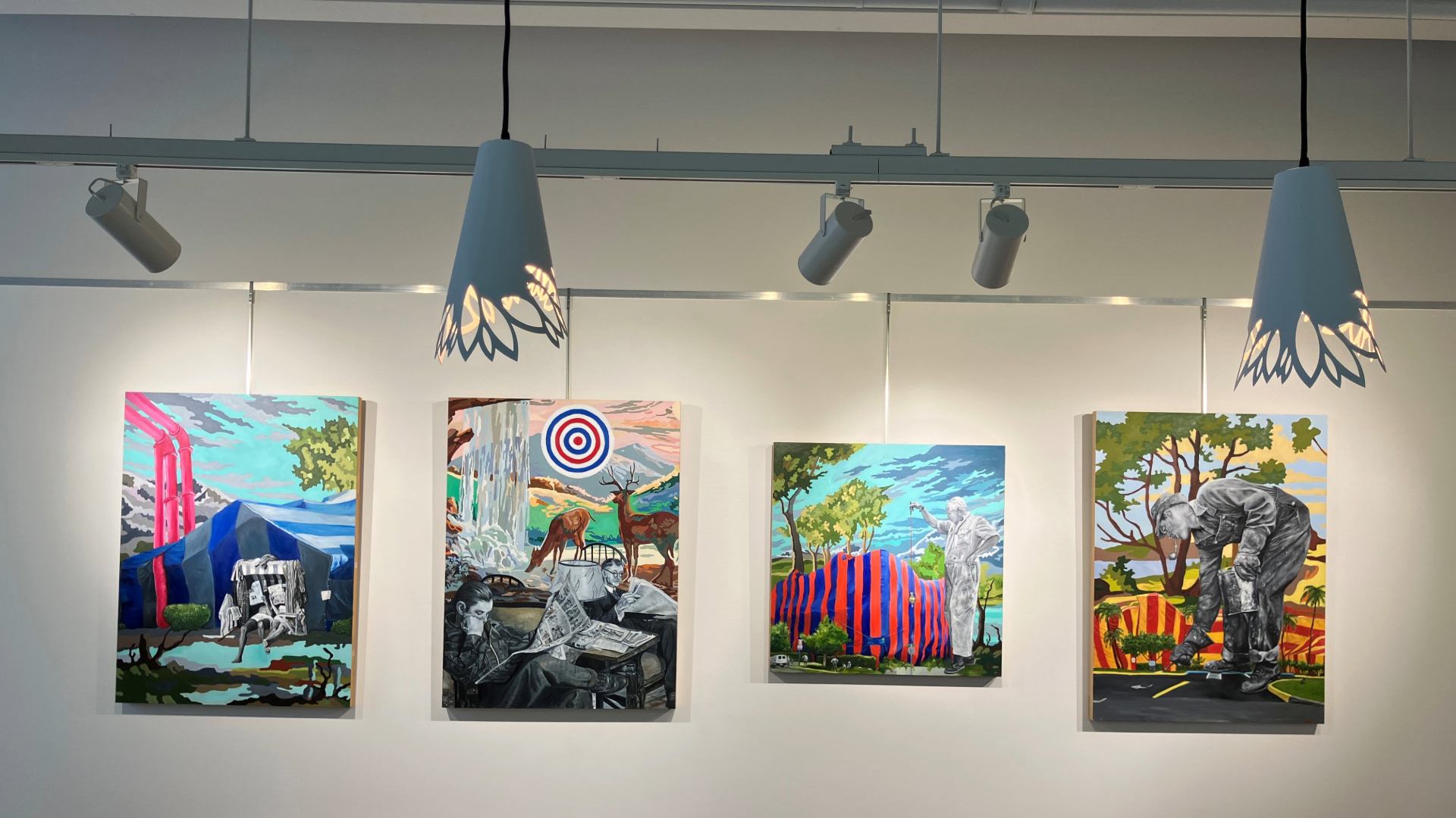 Colorful paintings hanging on a wall behind a front desk