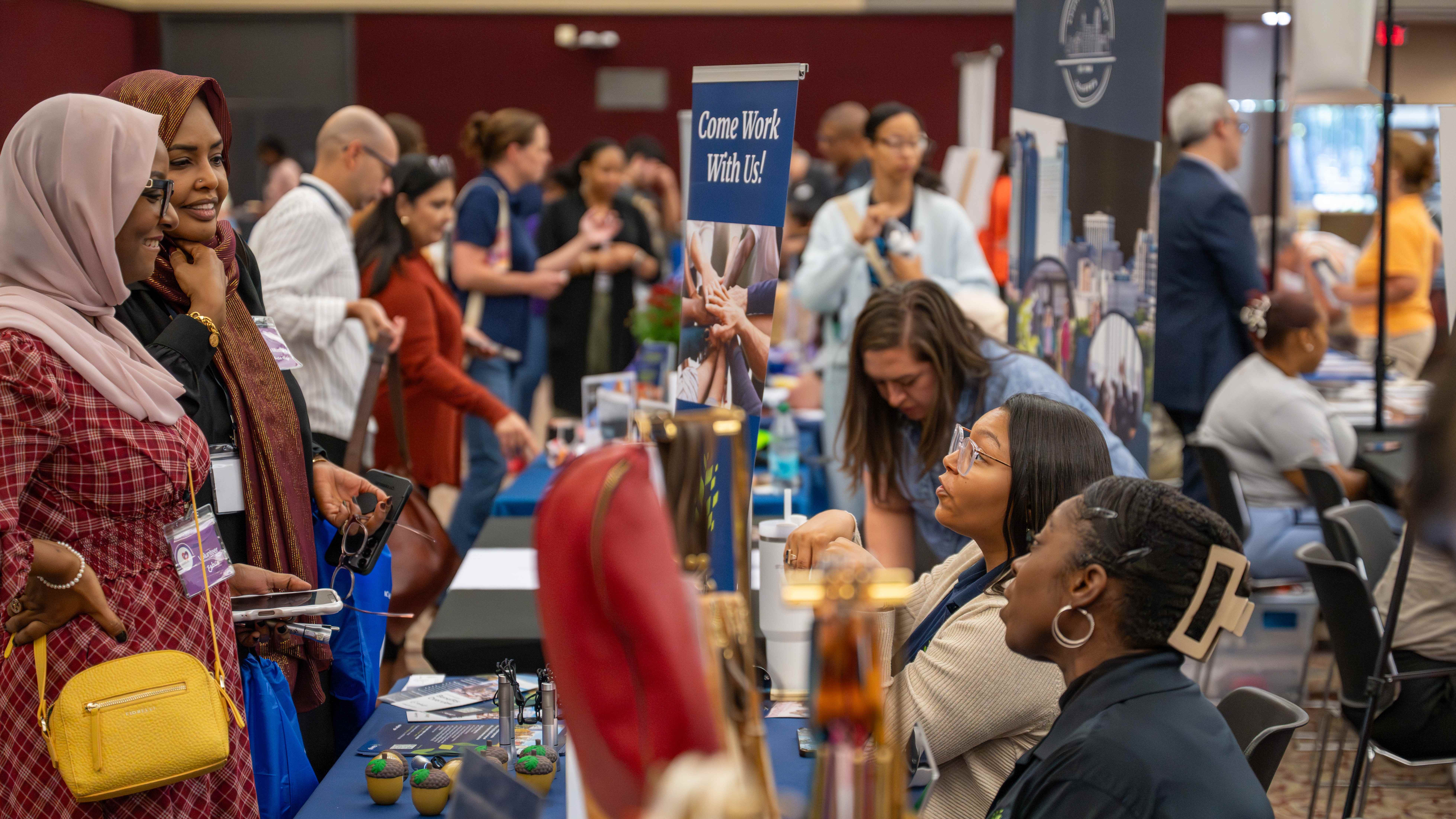 Residents engage with exhibitors at the expo