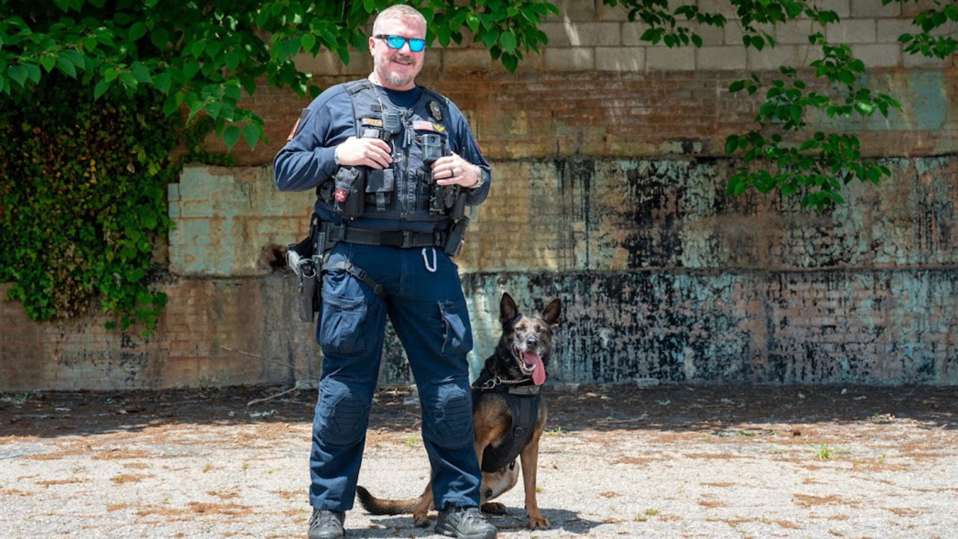 Raleigh Police Officer Green standing with Hugo.
