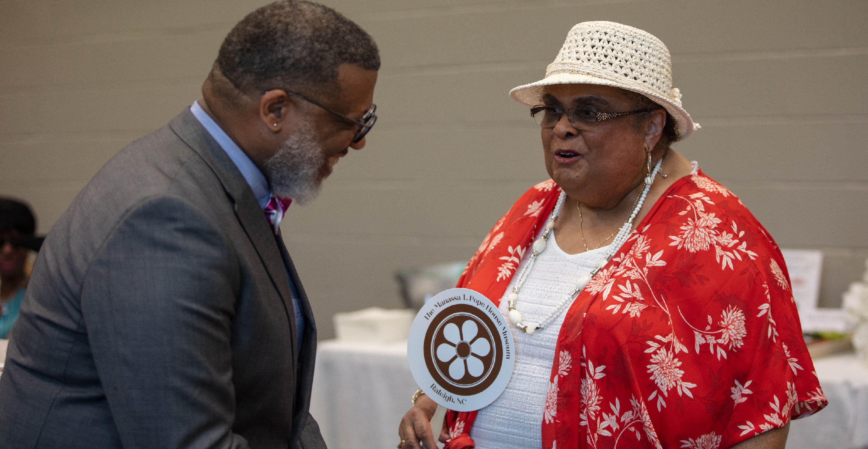 two people talking at a ceremony