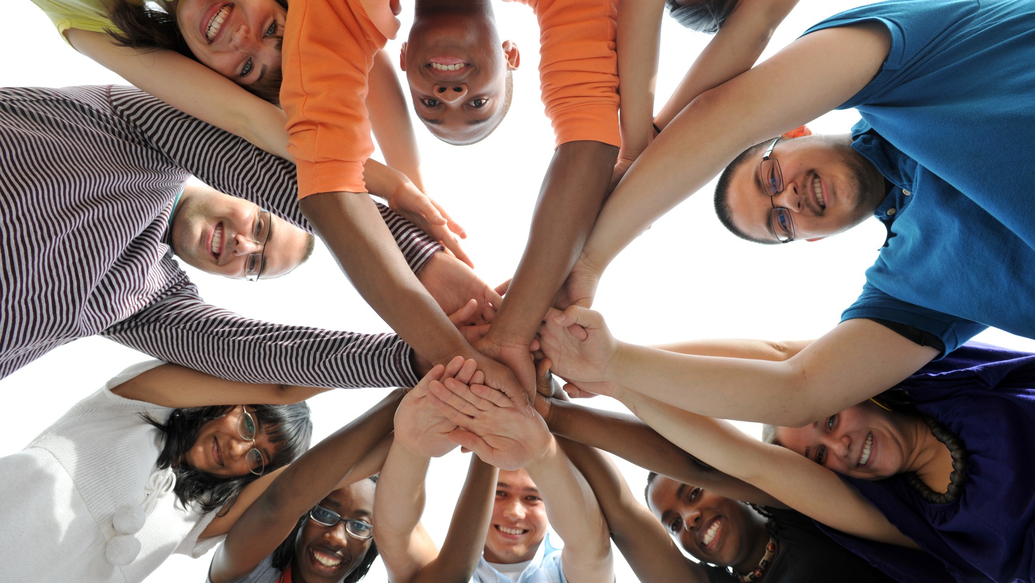 various people hold their hands towards the center