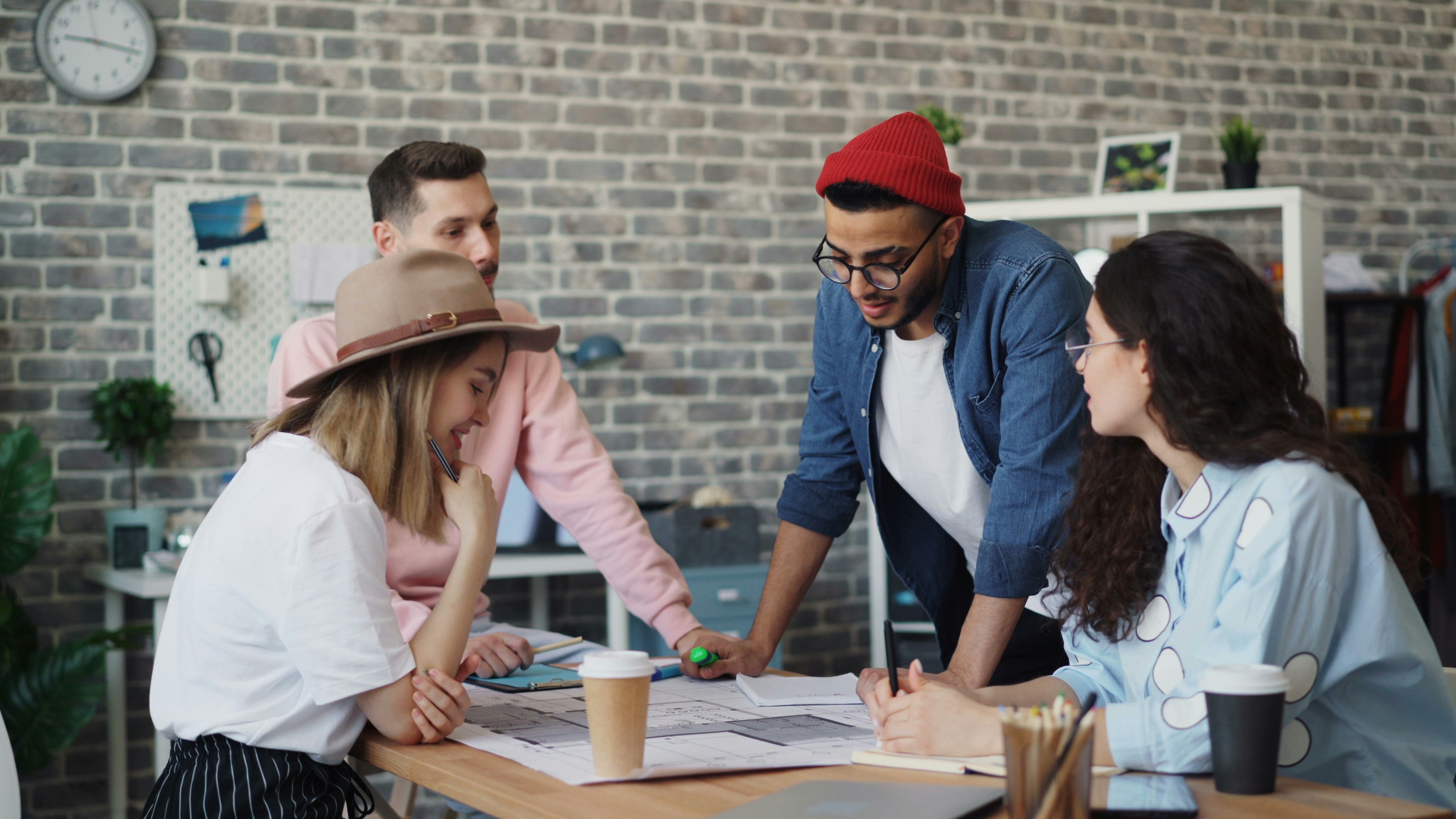 A group of adults huddle around a table planning something for their organization