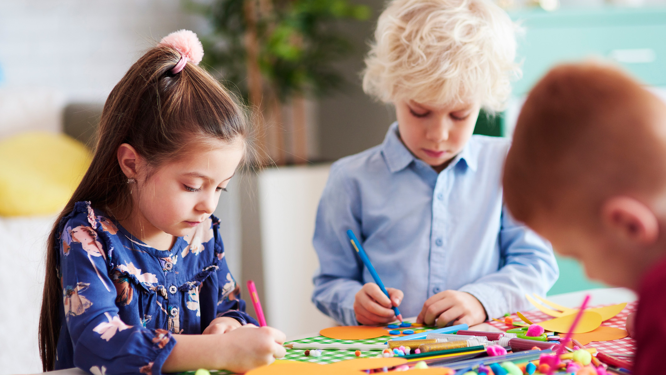 a group of focused children during an art program