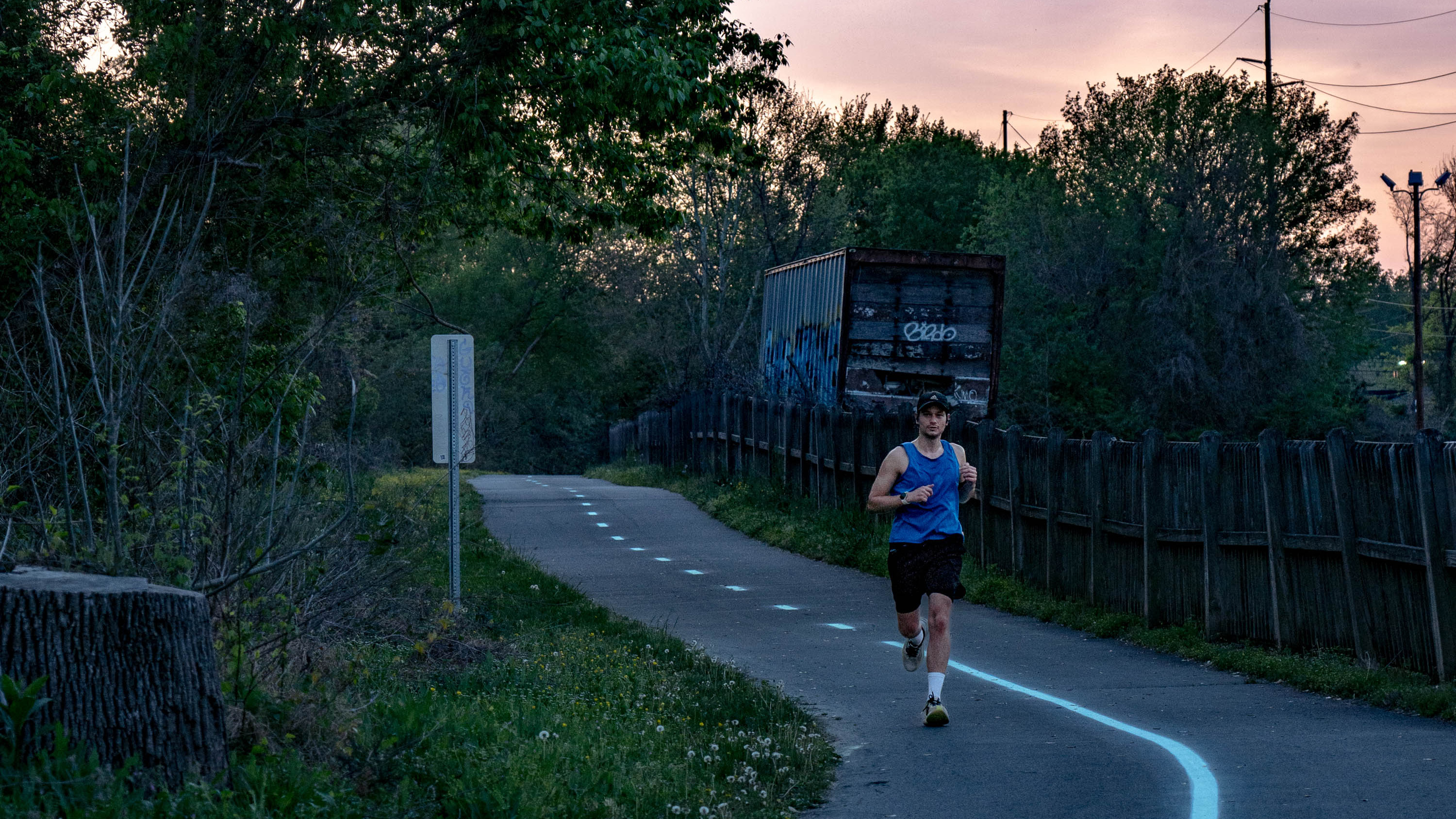 a runner on a paved trail