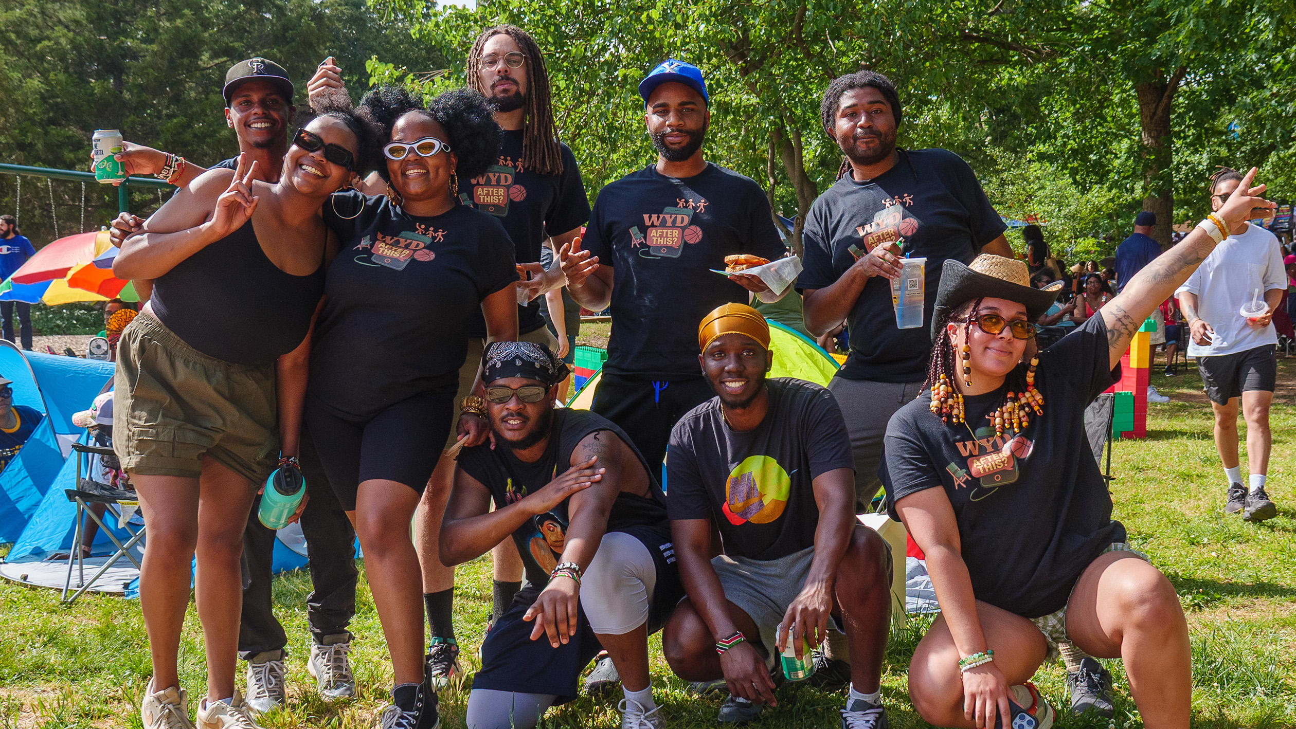 a group of people smiling at an outdoor event