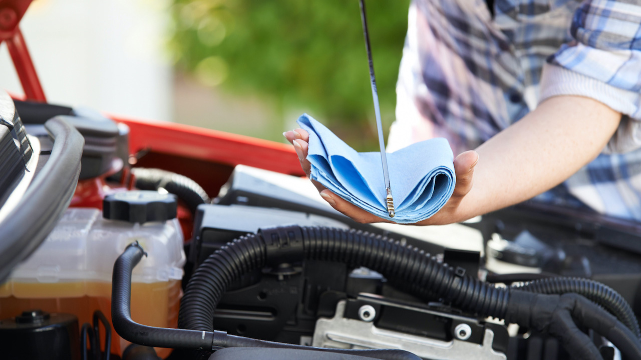 a person holding tools for car care