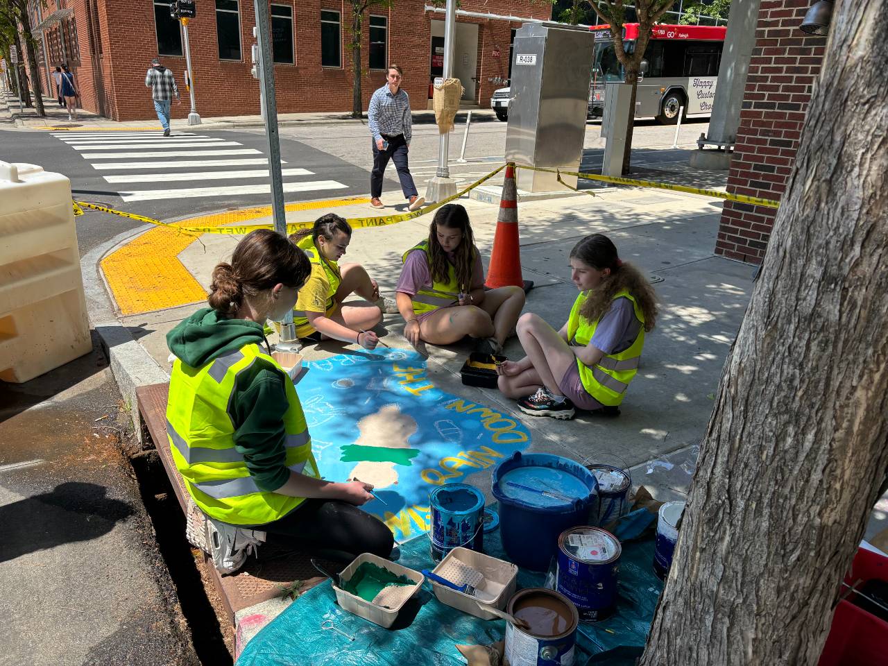 Artists completing street art