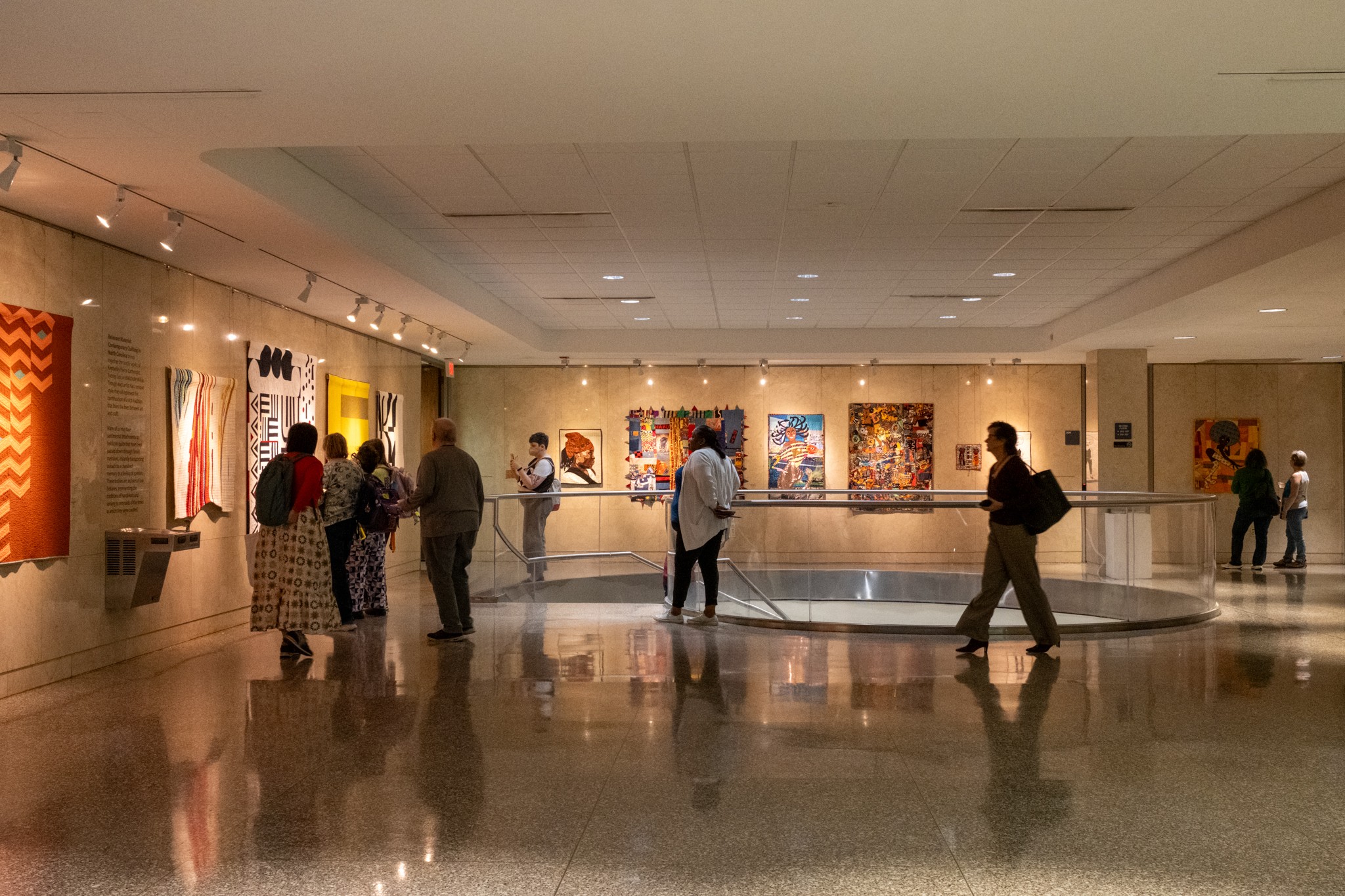 Gallery space with people enjoying an art opening 