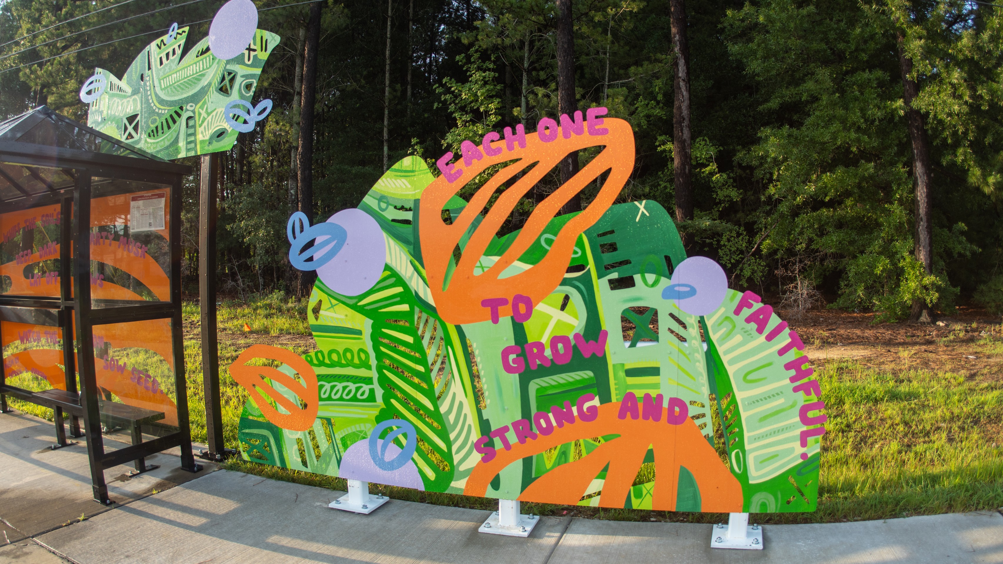 Colorful, artist-designed bus shelters and a sculptural bench along Poole Road and at the Neuse River trailhead. 