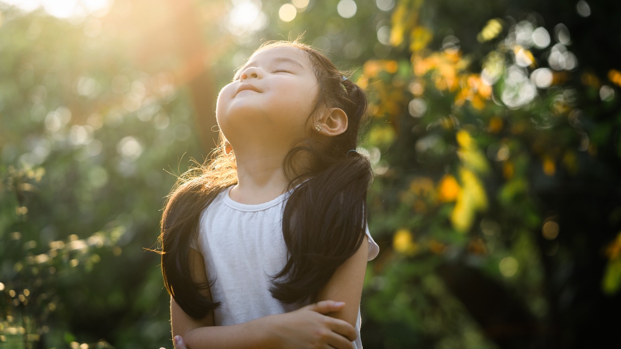 a girl outside that looks happy