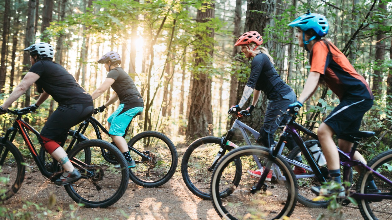 people on a trail mountain biking