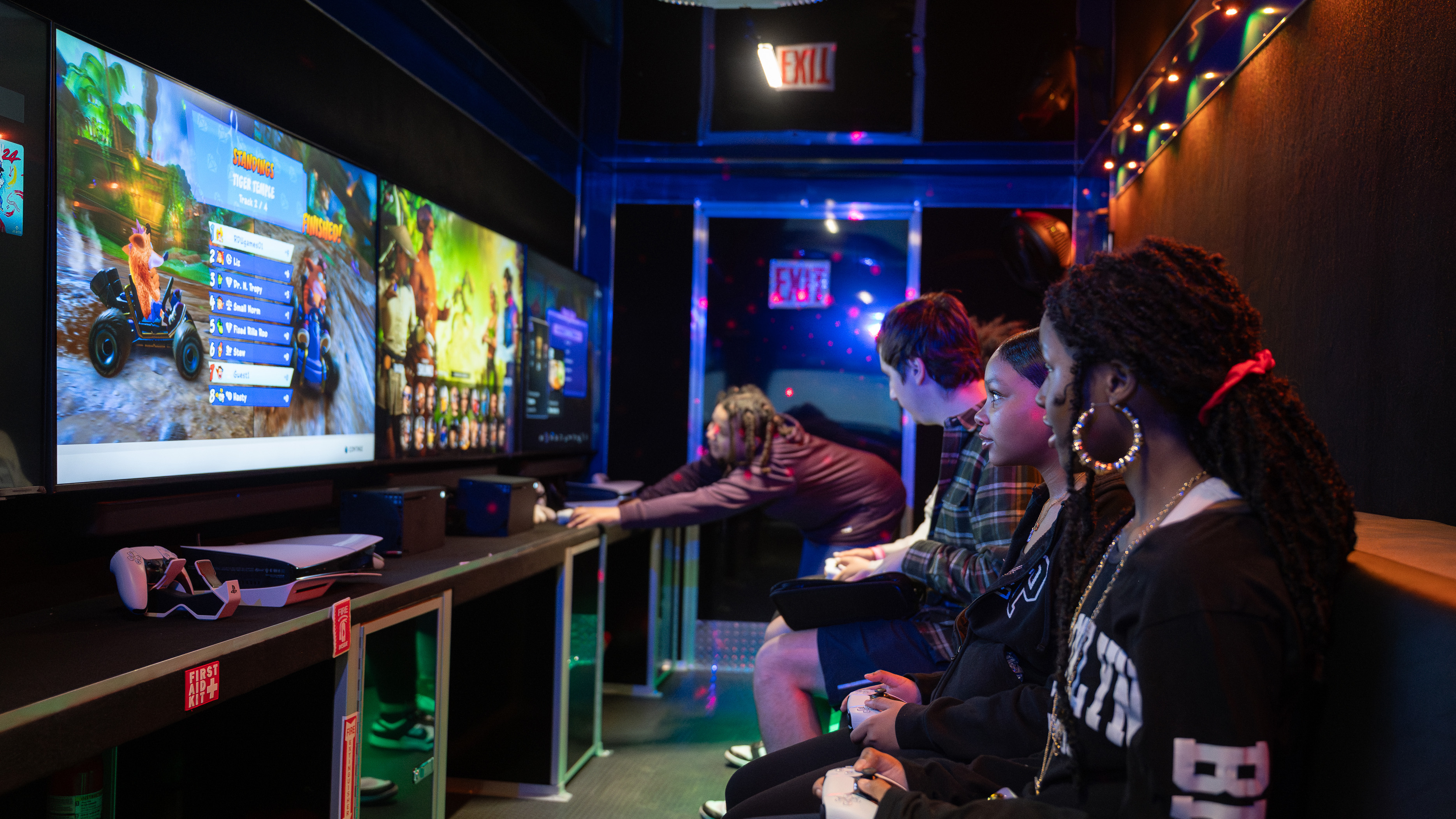 the inside of a gaming truck with young people playing video games