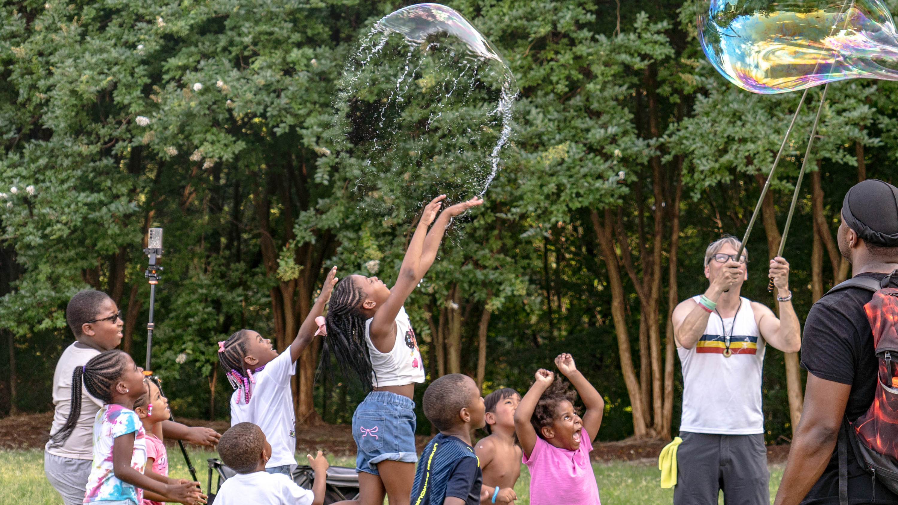 children playing with bubbles in a field