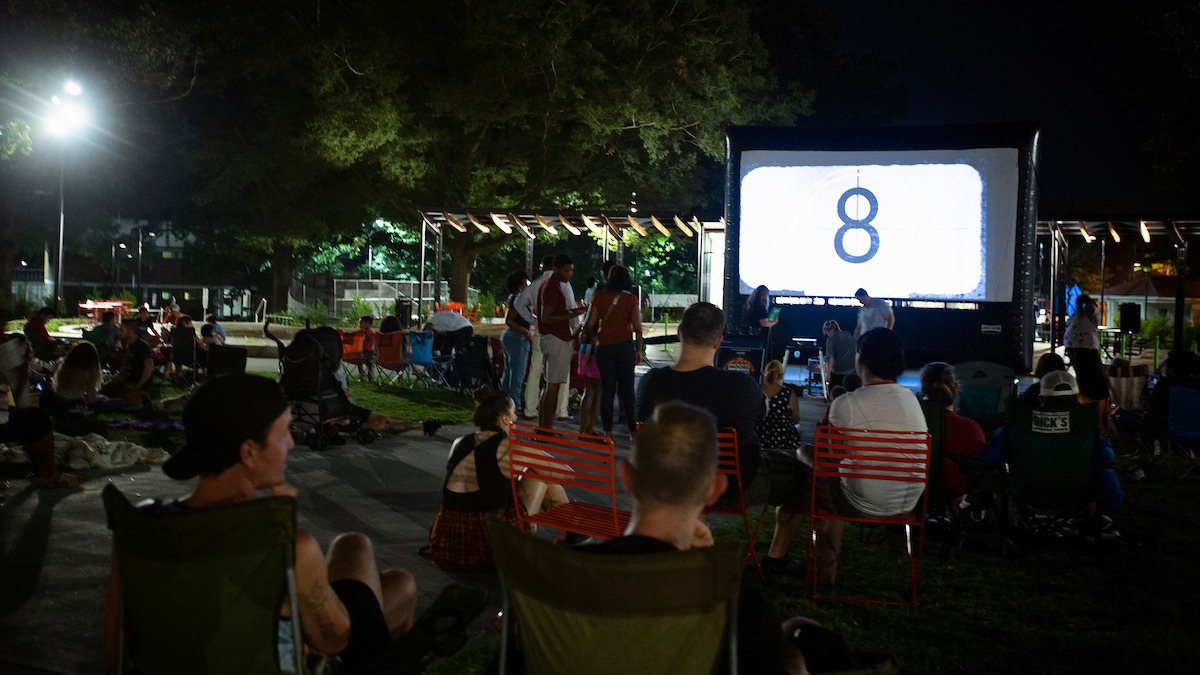 a crowd watching an outdoor movie