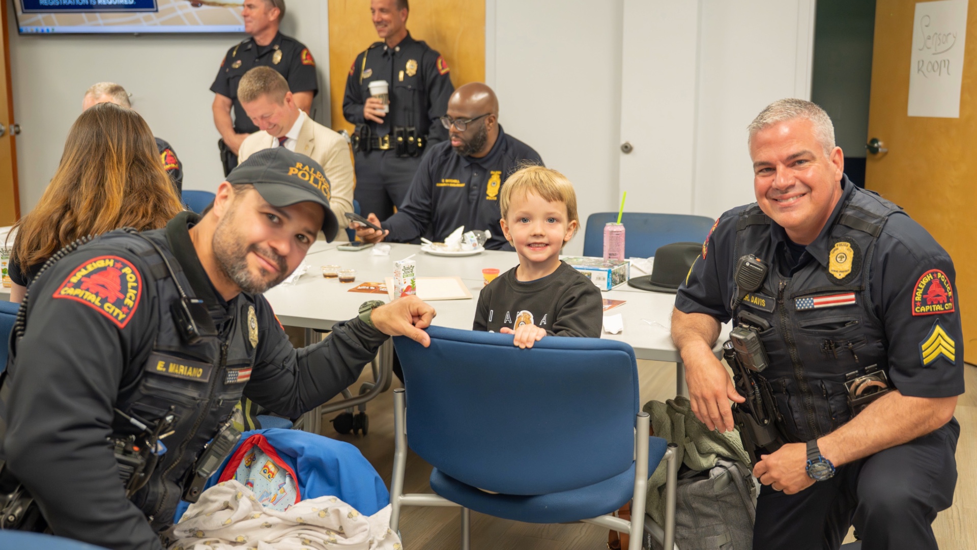 Child and police officers smiling