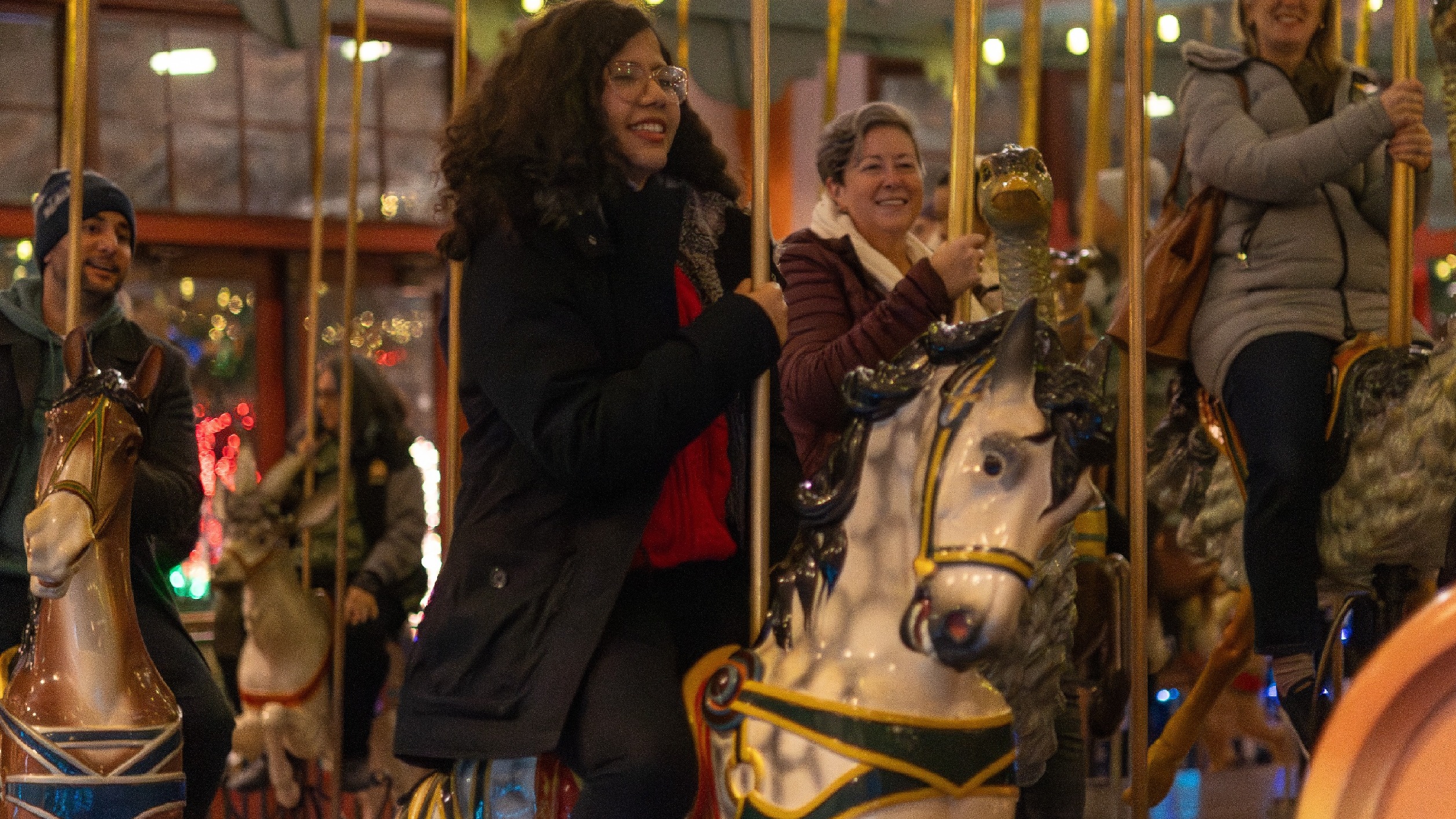 a person riding a horse on a carousel 