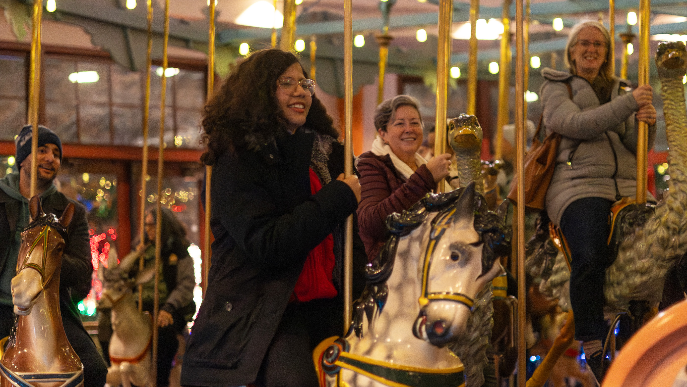a person riding a horse on a carousel 