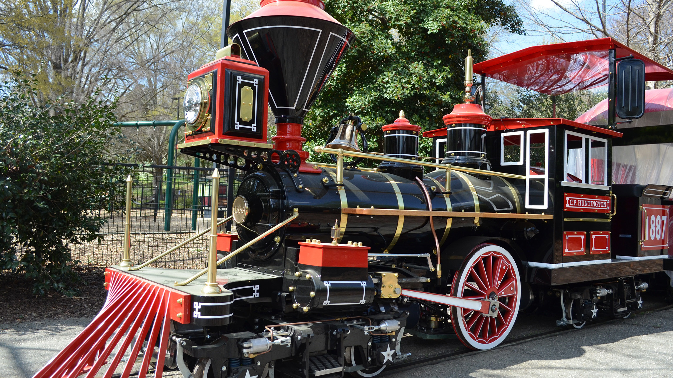 a black and red amusement train at Pullen park